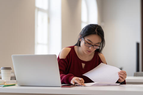 woman studying documents preparing for exam or test